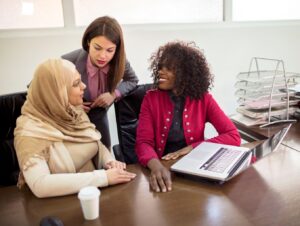 A group in discussion around a desk.