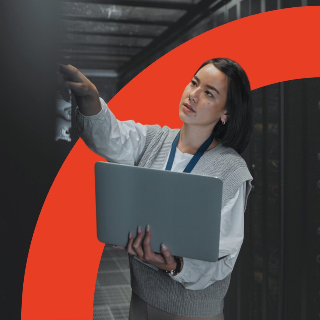 Image shows an east Asian person holding a laptop, a red arch intersects the image