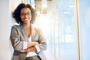 Person in a bright office smiling at the camera.